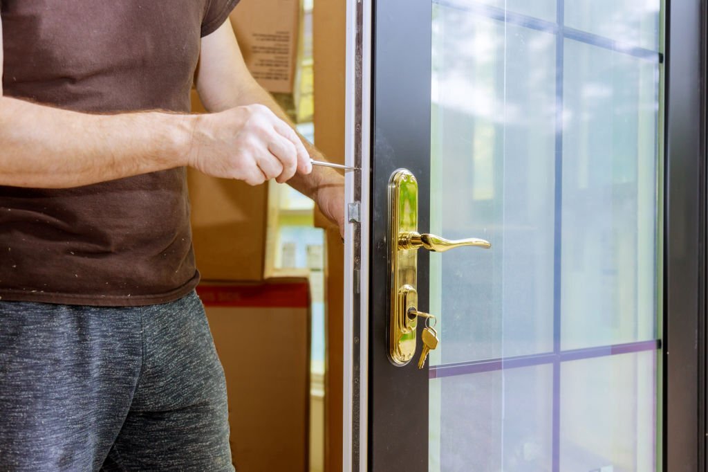 Worker installing door accessory.