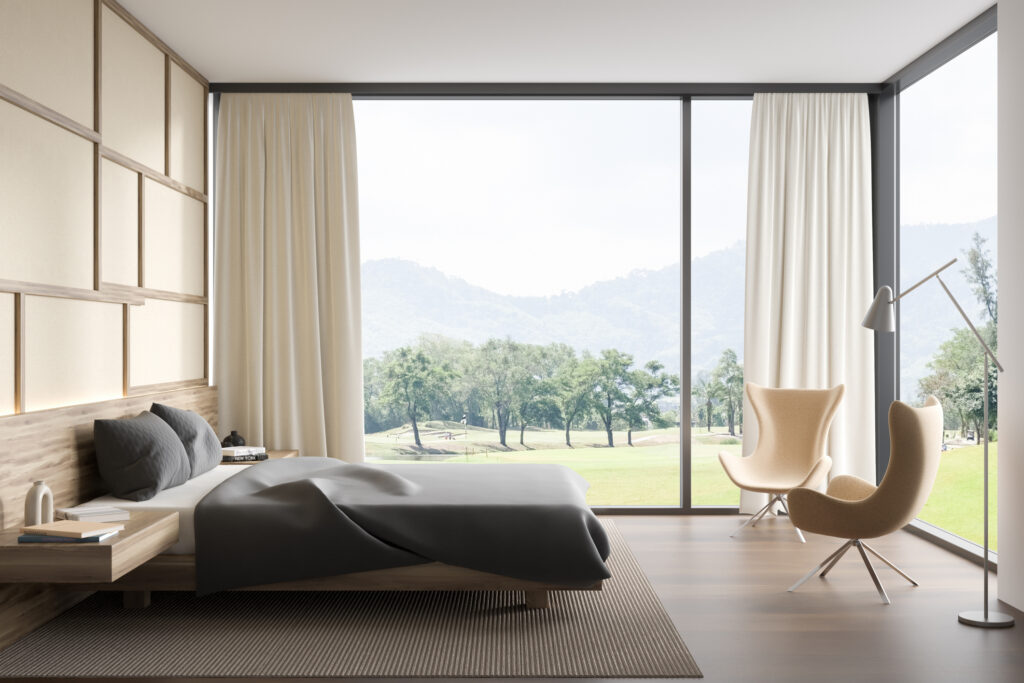 Corner bedroom window with two armchairs. 