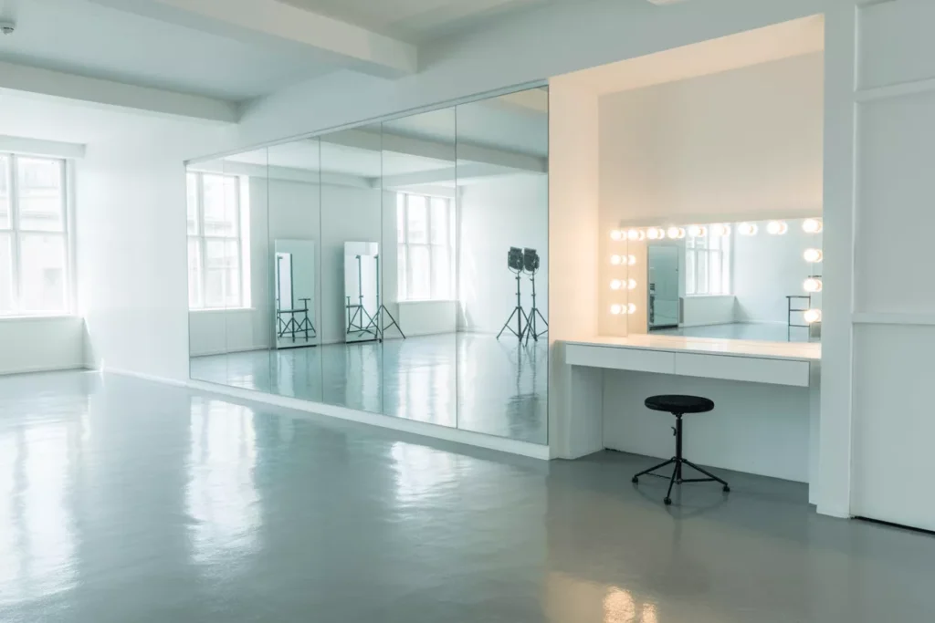 Studio interior with low-iron mirrors, LED vanity mirrors, and acrylic safety mirrors showing accurate reflections, professional lighting, and high-clarity surfaces for filming and photography.
