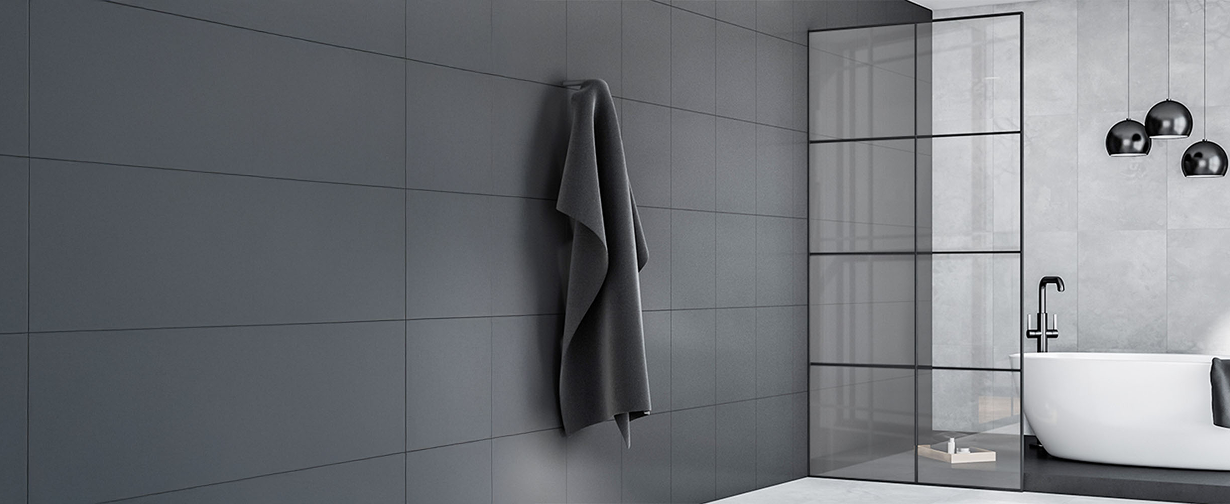 Modern bathroom with black Grid shower glass door and freestanding bathtub, featuring sleek walk in shower doors.