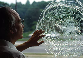 Shattered laminated glass with bulletproof security features, enhancing safety in high-risk areas like banks and offices