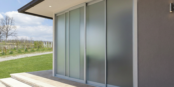 Large frosted panels for glass sliding doors opening to a sunny green garden
