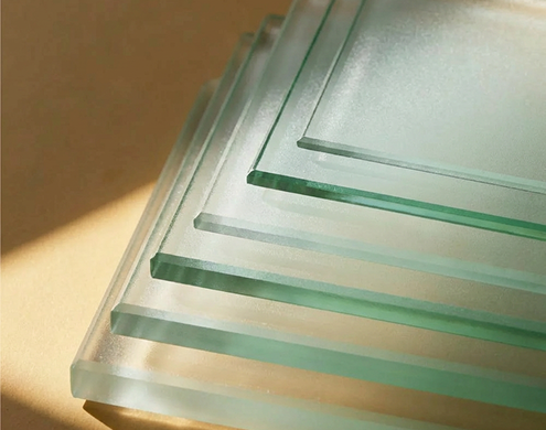 Stack of frosted glass sheets glowing in warm natural light