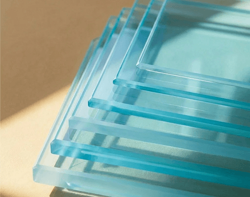 Stacked layers of blue tempered glass sheets with vibrant blue tint.