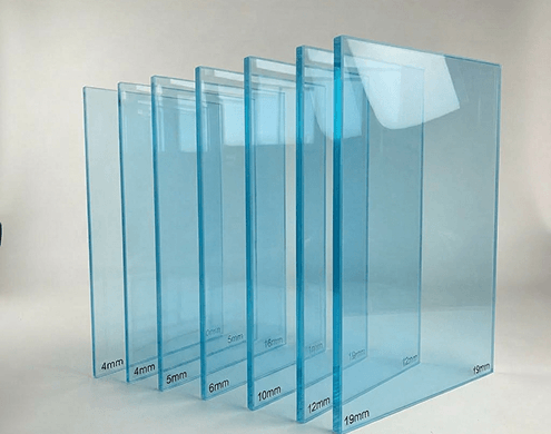 Blue tempered glass samples displayed in increasing thicknesses from 4mm to 19mm with blue tint.