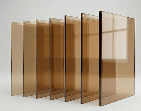 Uniform bronze tempered glass panels showcasing custom cut precision and polished edges for premium applications.