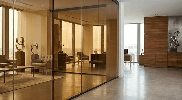 Modern office partition using bronze tinted tempered glass for sophisticated design and custom cut precision.
