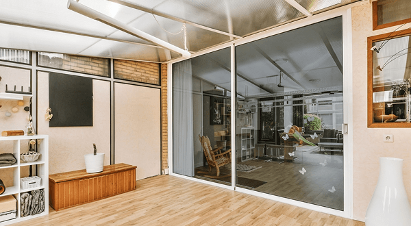 Bright modern interior featuring large sliding doors with ECL tinted grey glass panels.