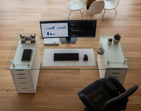 Glass top for Alex drawers on sleek white office desk with dual monitors