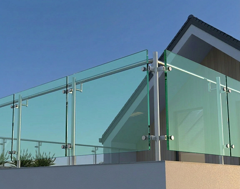 Modern glass with green tint balcony railing with sleek stainless steel fittings and brackets