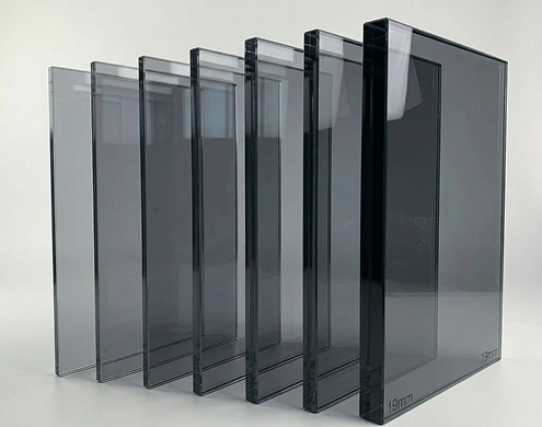 Modern round coffee table with light gray glass top and chrome base