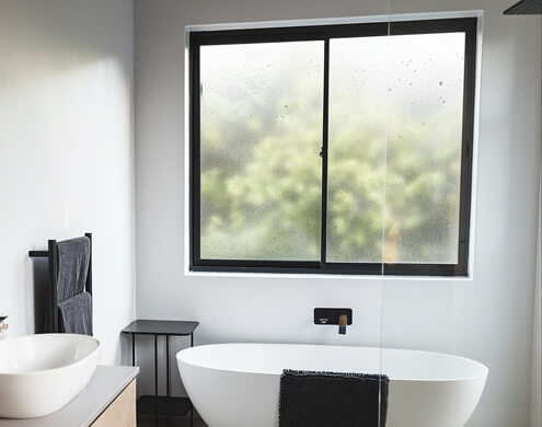 Modern bathroom featuring Spraylite tempered glass window for privacy and natural light