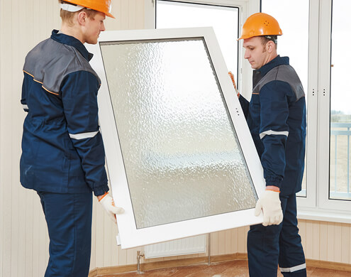 Professional team handling Spraylite tempered glass cut to size for installation