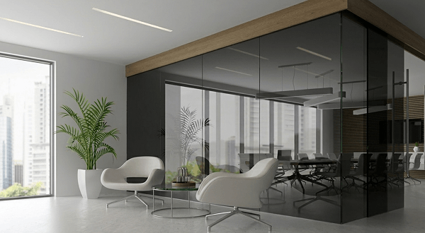 Modern office interior featuring a sleek super grey toughened glass partition wall with reflections and contemporary white furniture.