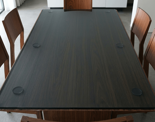 Modern round table with Super Grey glass top in a contemporary setting