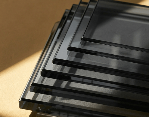 Stack of super grey tempered glass sheets with smooth polished edges.
